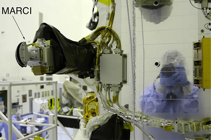 Image of MARCI onboard the MRO spacecraft. Reflection on spacecraft body shows MSSS's Mike Ravine, the MARCI/CTX Instrument Manager, taking the picture.